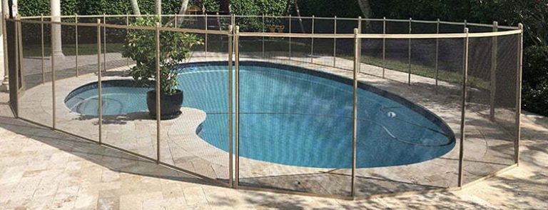 Elegant curved pool fence installed around a backyard pool in Broward County, providing safety and enhancing the pool's aesthetics.