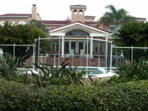Elegant mesh pool fence installed around a luxury backyard pool in Tampa Bay