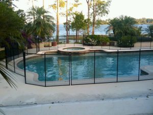 Mesh pool fence installed in Lakeland backyard overlooking a lake