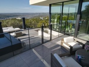 Modern black mesh pool fence installation on a luxury Houston balcony overlooking a scenic view