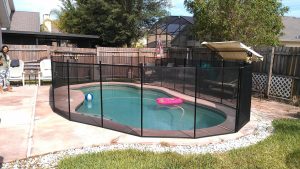 Mesh pool fence installation in Orlando backyard for safety and enclosure
