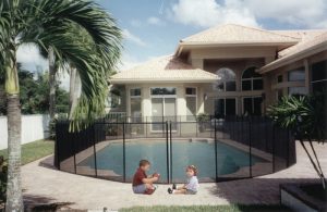 Mesh pool fence protecting backyard pool area in Sarasota FL