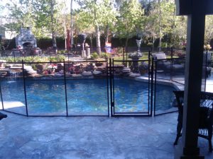 Mesh pool fence in Orlando FL installed for child safety around a curved pool