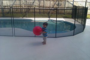 Safety mesh pool fence installed around backyard pool in Lakeland Florida