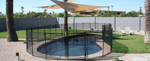 Stylish mesh pool fence around Riverside backyard swimming area