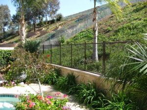 Pool fence in Santa Barbara surrounding a hillside garden, ensuring safety for families and pets