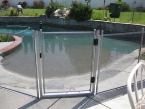 Pool fence in Santa Barbara with a secure gate installation, enhancing safety around the swimming pool