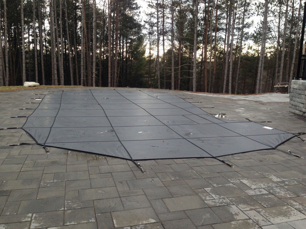 Black winter pool cover in the cold.