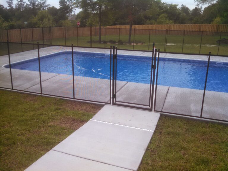 Pool fence installed around backyard pool as part of pool cover vs. pool fence safety comparison