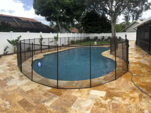 Black mesh pool safety fence around a residential swimming pool in Ocala, FL