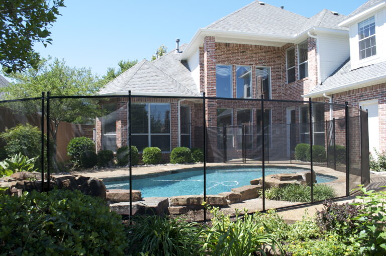 Tempe backyard pool secured with removable mesh safety fence and desert-style hardscaping