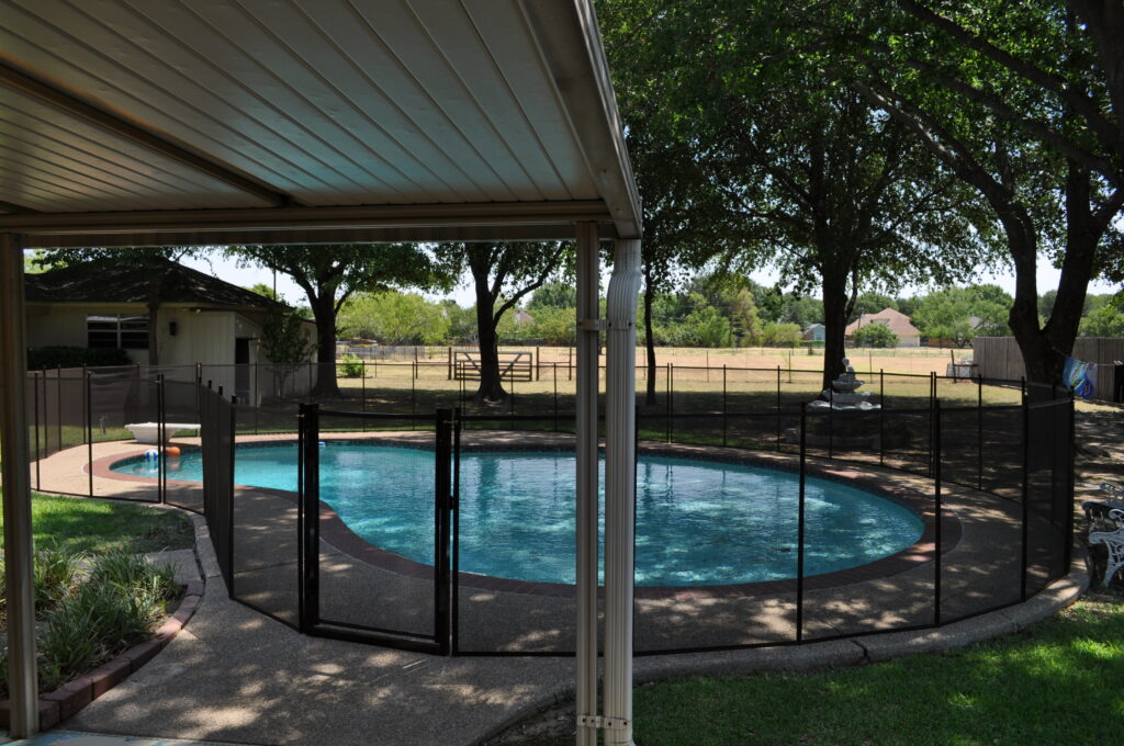 Pool safety fence installed around a residential pool in Connecticut, ensuring compliance with pool fence requirements