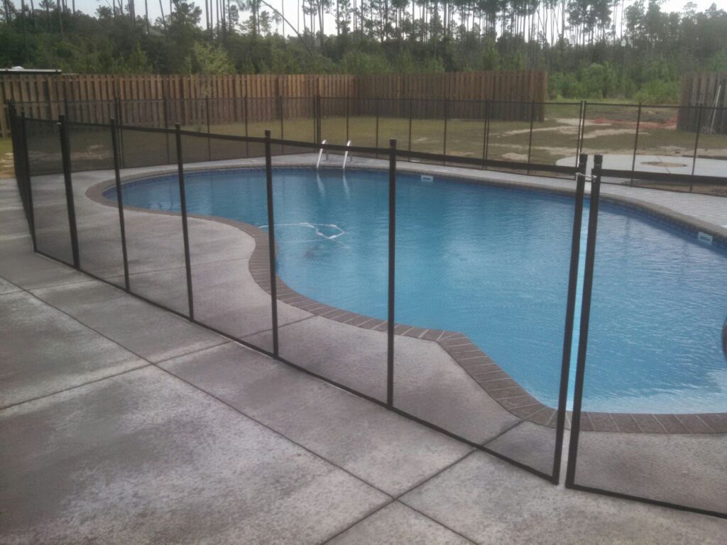 Black mesh pool safety fence installed around a residential pool in Georgia to meet safety requirements