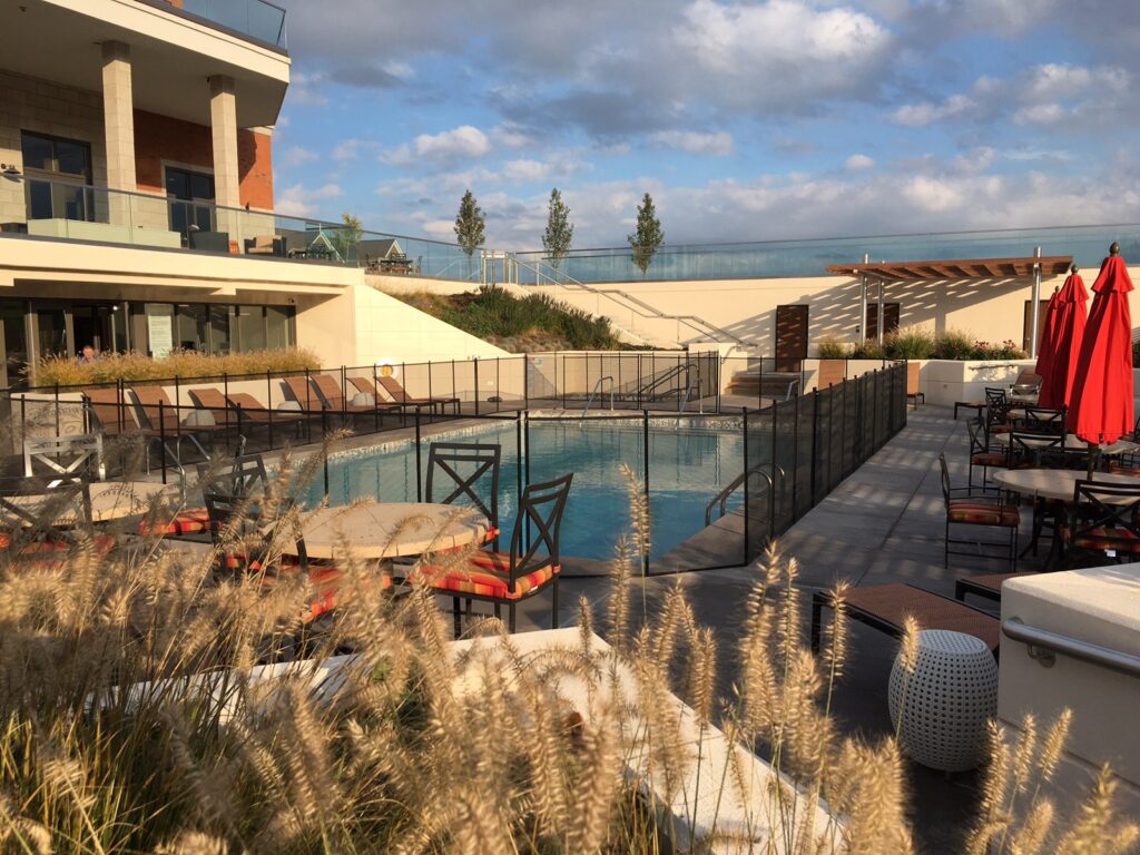 Commercial pool area with black mesh fence ensuring safety compliance