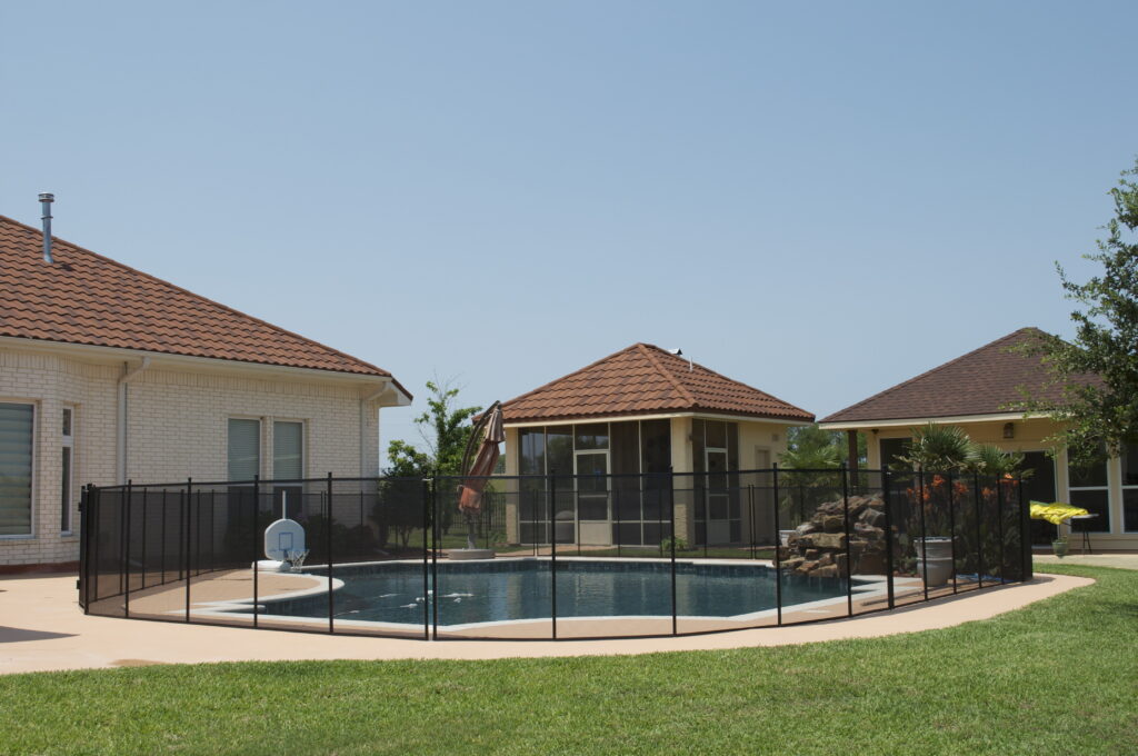 Best pool fence for Las Vegas weather shown around a backyard pool with mesh panels and desert-ready landscaping
