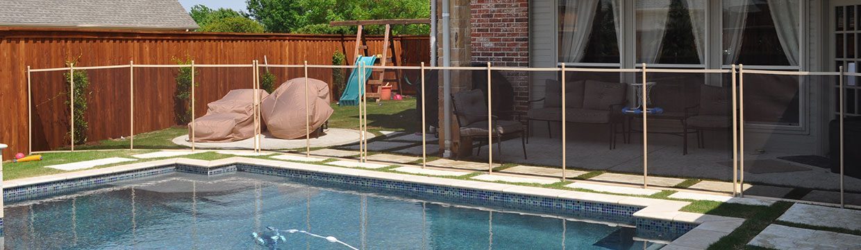Pool fence installation by Pool Guard USA around a backyard swimming pool for child safety.